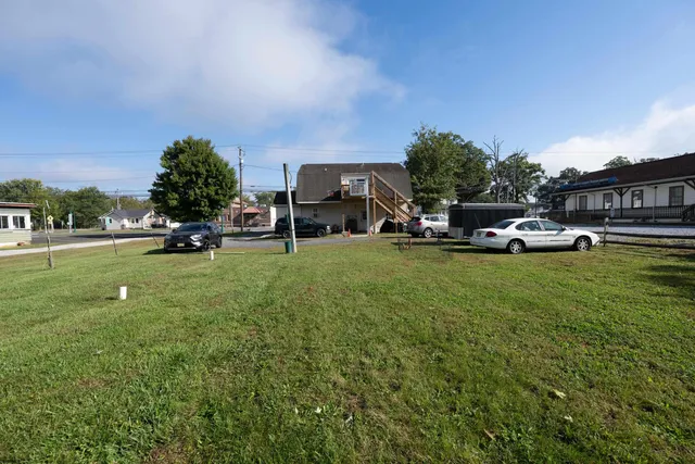 a view of a house with backyard and sitting area