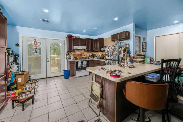 a kitchen with stainless steel appliances kitchen island granite countertop a sink and cabinets