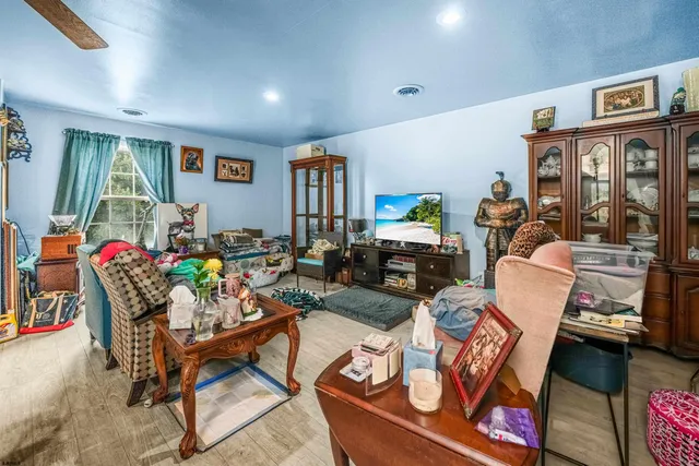 a living room with furniture a window and a flat screen tv