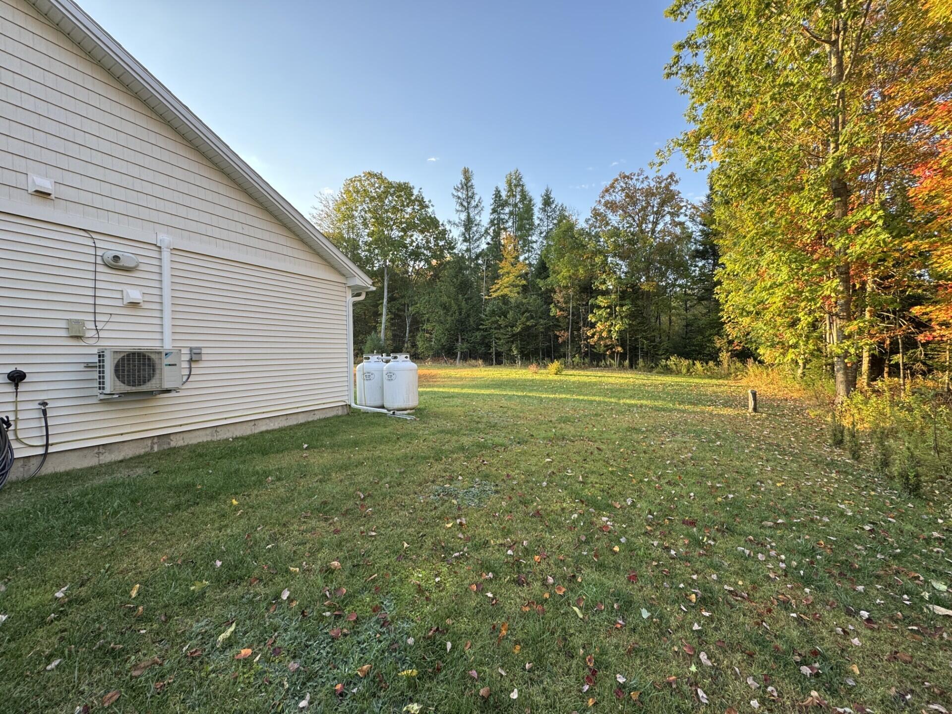 5 Chestnut Street Unity, ME 04988 - Photo 4 of 24 Side yard & Heat pump
