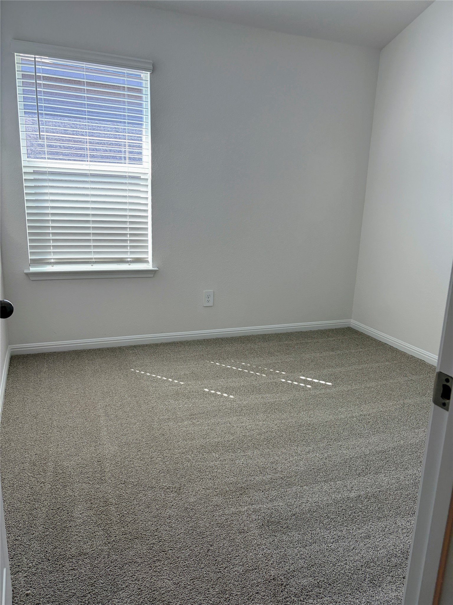 440 El Capitan Loop Dripping Springs, TX 78620 - Photo 15 of 22 Carpeted spare room featuring baseboards