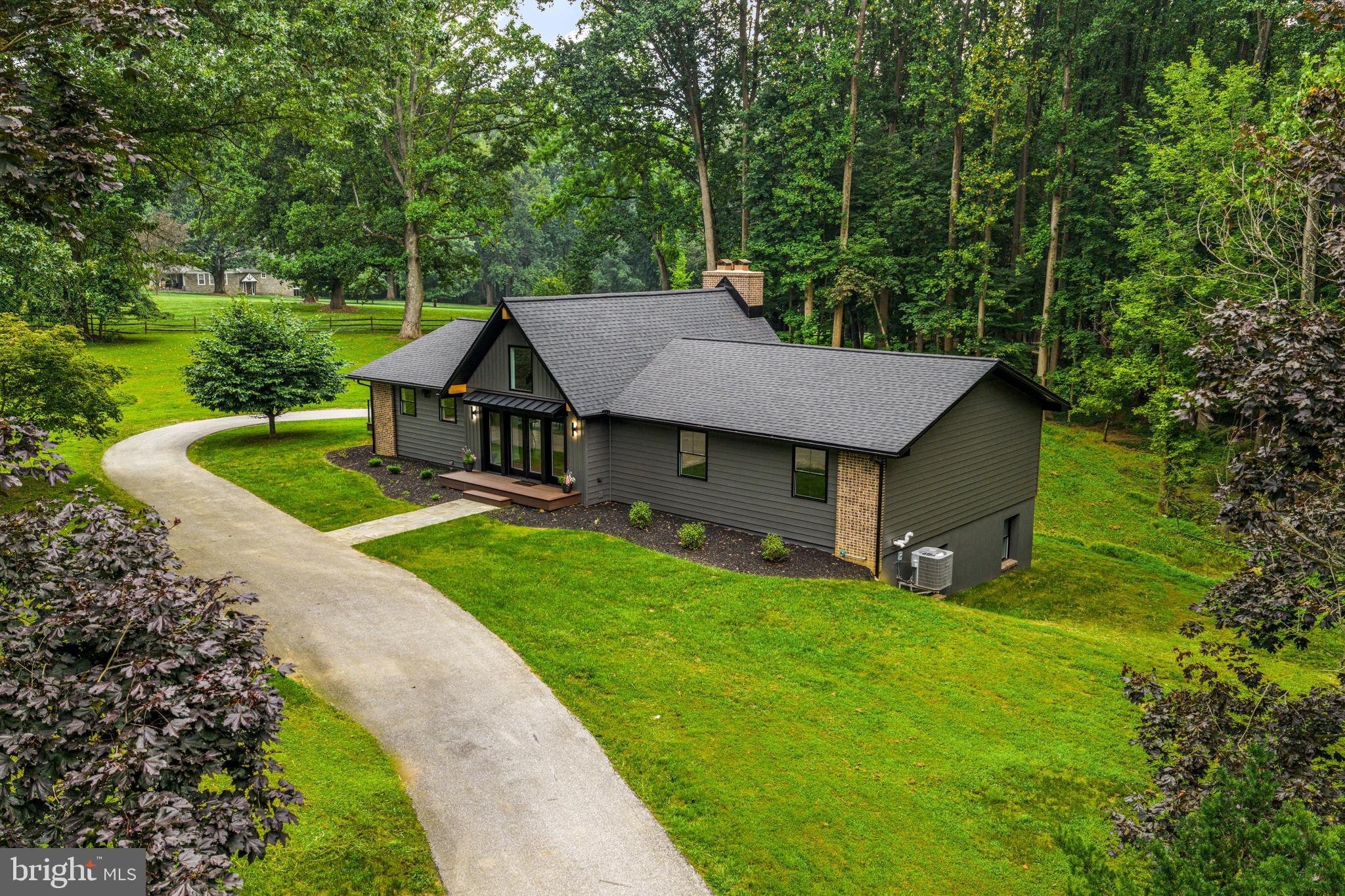 a view of a house with a yard and tree s