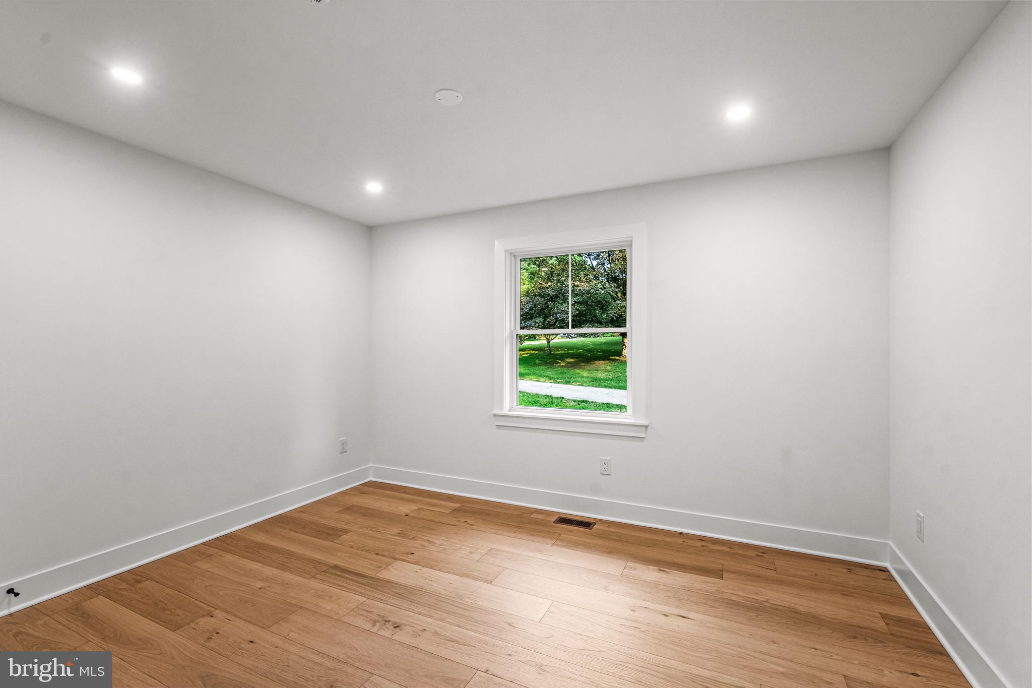 615 Cricklewood Road West Chester, PA 19382 - Photo 18 of 58 an empty room with wooden floor and windows