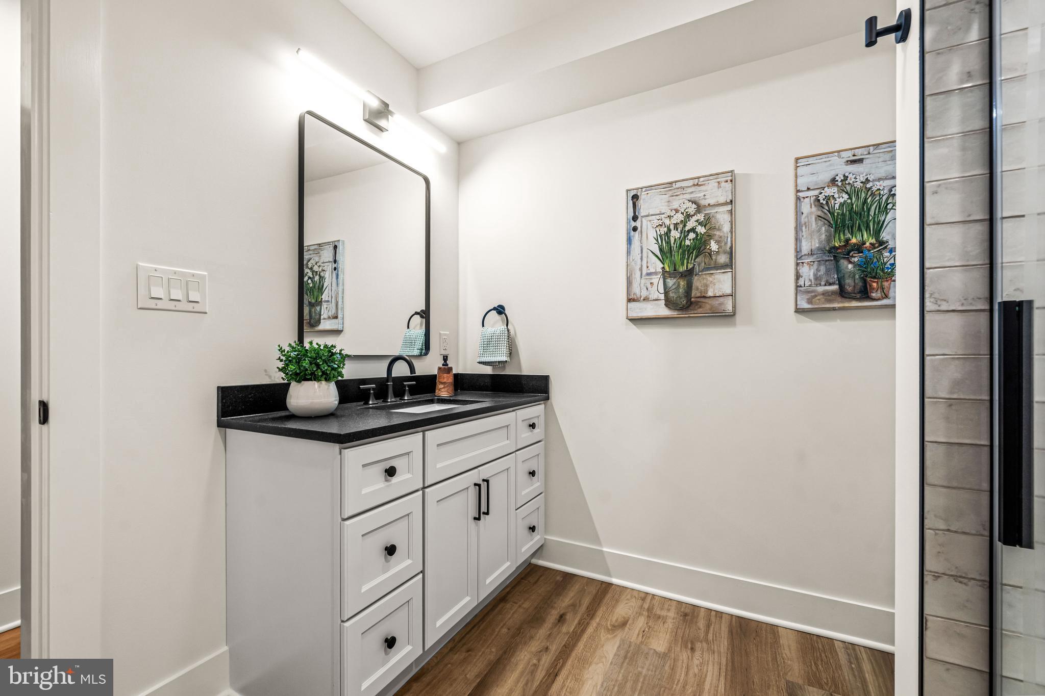 615 Cricklewood Road West Chester, PA 19382 - Photo 33 of 58 a bathroom with a granite countertop sink a vanity and a large mirror