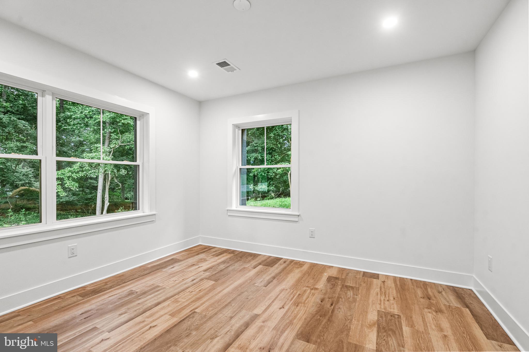 615 Cricklewood Road West Chester, PA 19382 - Photo 34 of 58 an empty room with wooden floor and windows