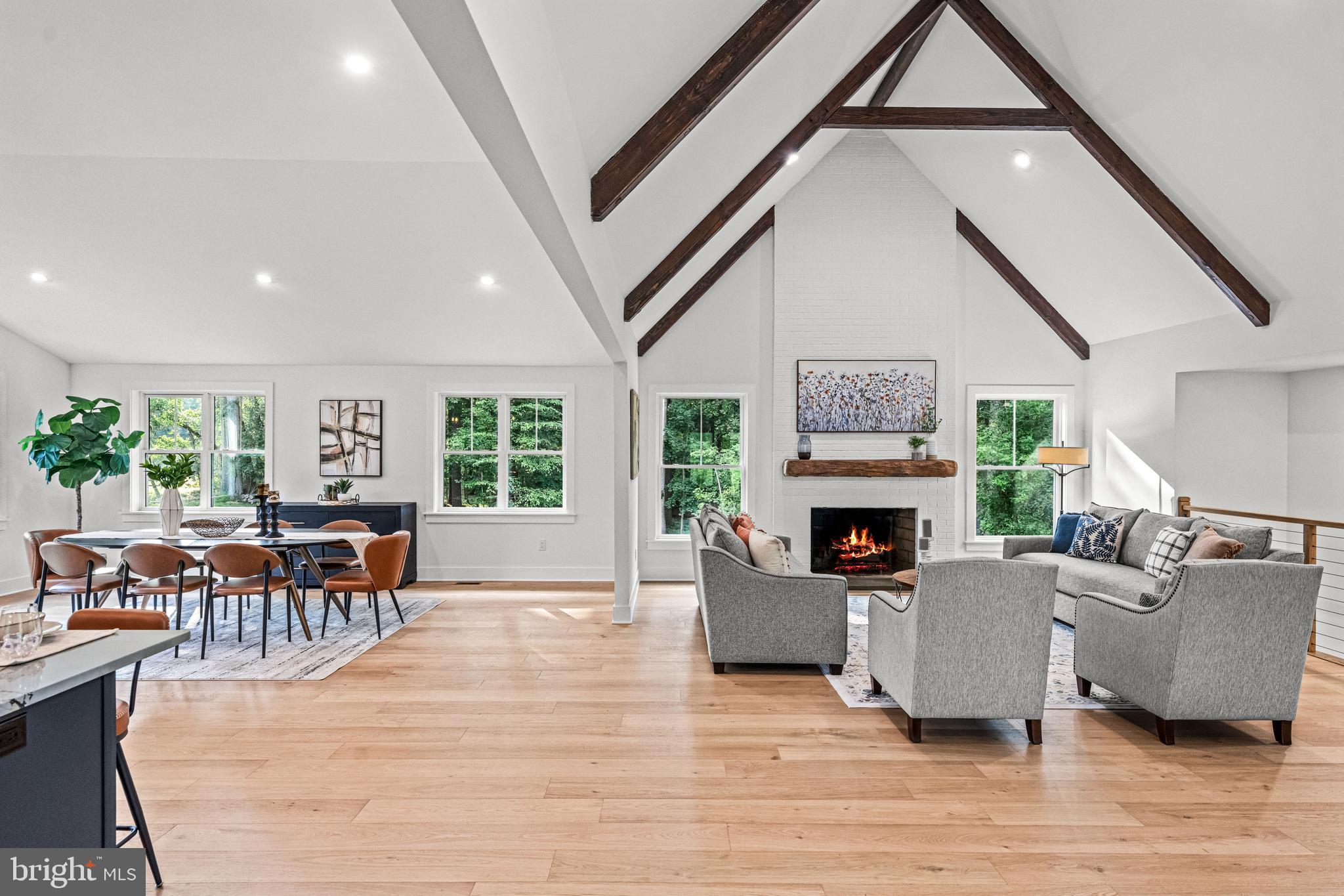 615 Cricklewood Road West Chester, PA 19382 - Photo 7 of 58 a living room with furniture a fireplace and a floor to ceiling window