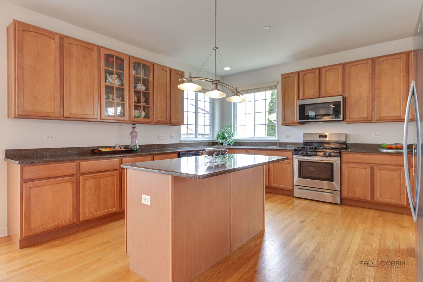 1330 Horizon Trail Wheeling, IL 60090 - Photo 16 of 39 a kitchen with stainless steel appliances granite countertop a stove a sink dishwasher a refrigerator and a microwave oven with wooden floor