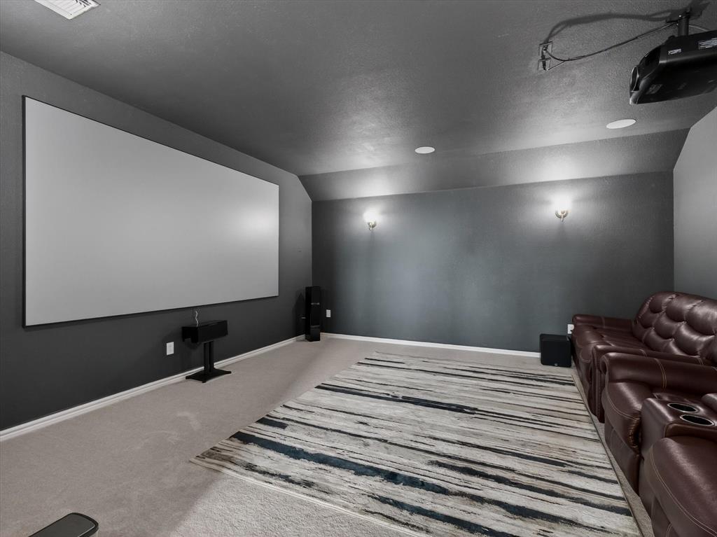 636 Corner Post Path Celina, TX 75009 - Photo 27 of 40 Dedicated media room featuring a large projection screen, projector, and recessed lighting