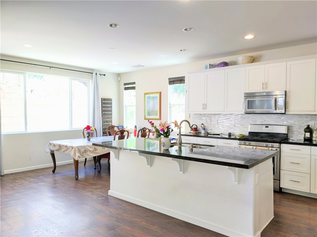 11811 Cramer Road Yucaipa, CA 92399 - Photo 17 of 56 a kitchen with lots of counter top space and dining table
