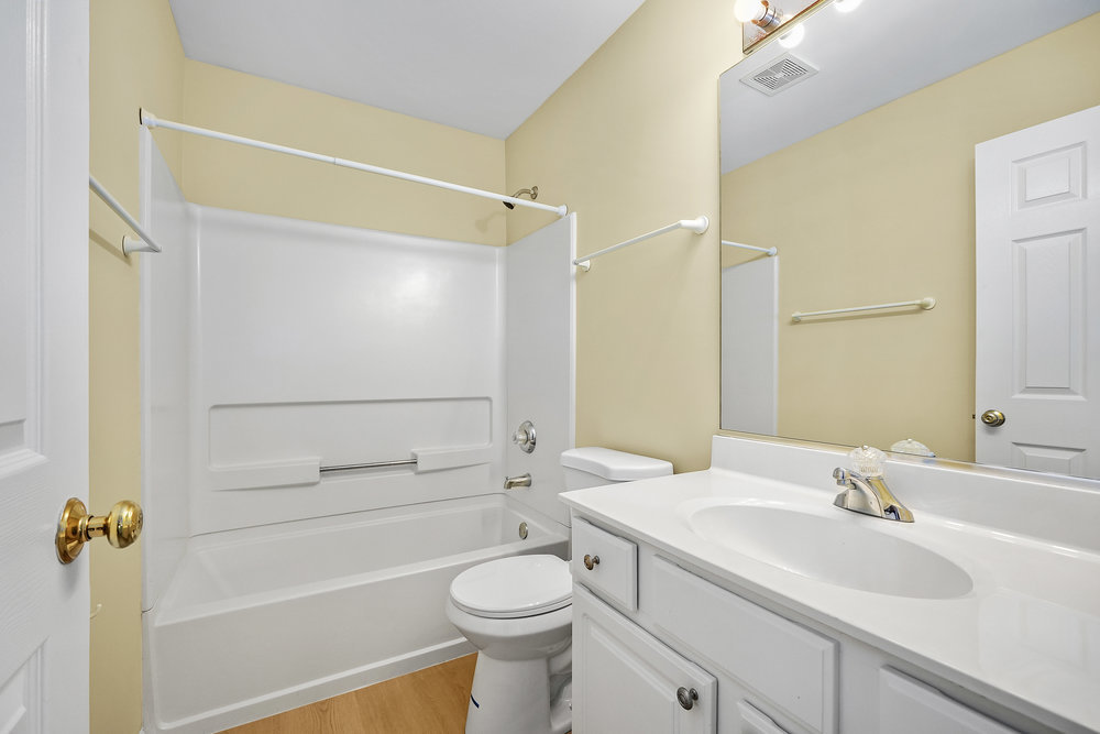 2277 Reflections Drive, Unit 2277 Aurora, IL 60502 - Photo 8 of 15 a bathroom with a sink a toilet and shower