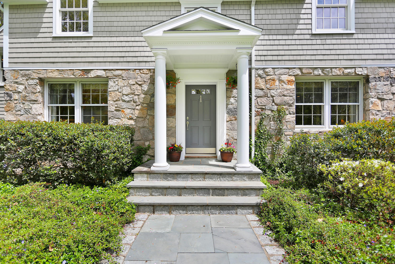 87 Hunting Ridge Road Stamford, CT 06903 - Photo 2 of 31 a front view of a house with potted plants