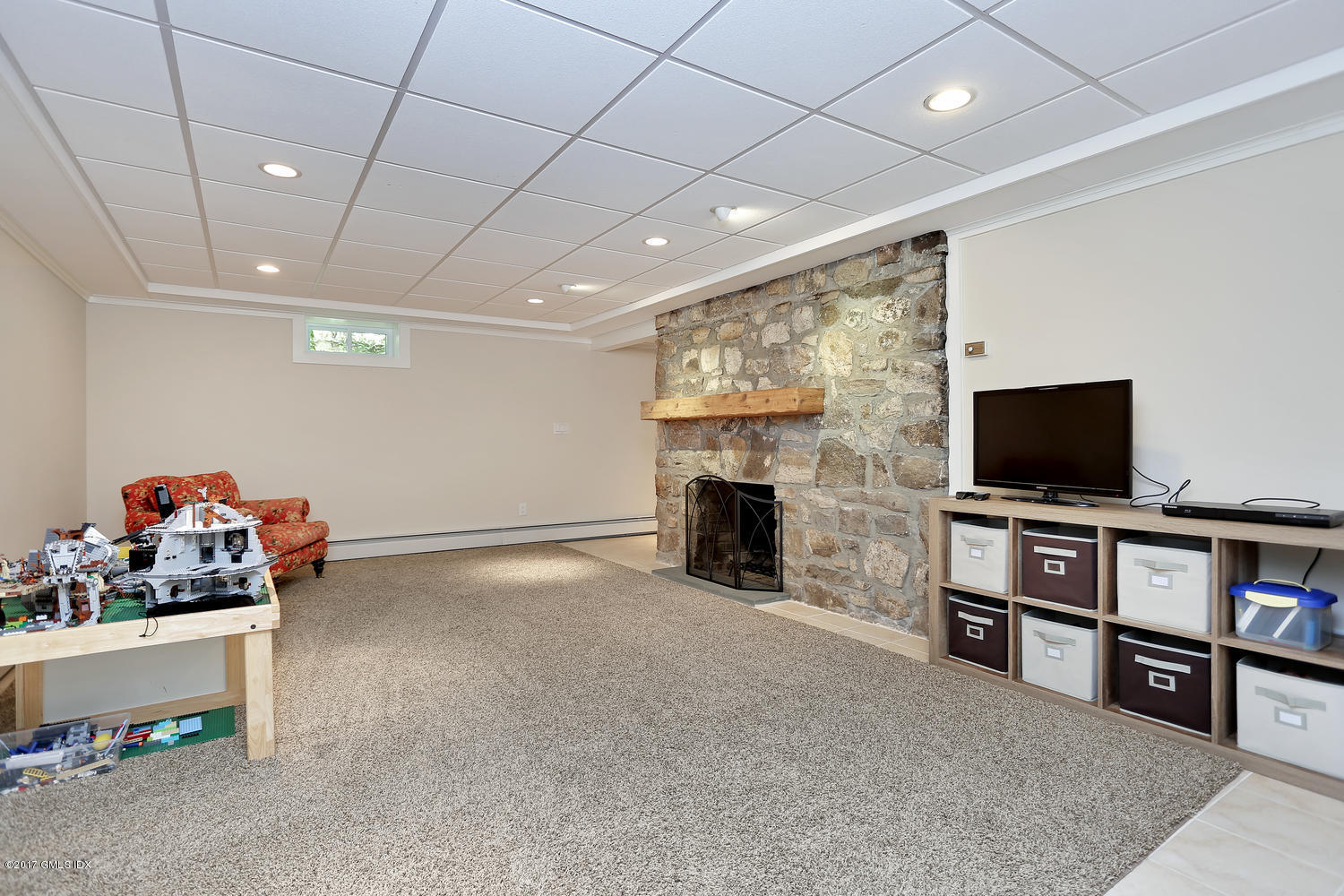 87 Hunting Ridge Road Stamford, CT 06903 - Photo 23 of 31 a living room with furniture and a flat screen tv
