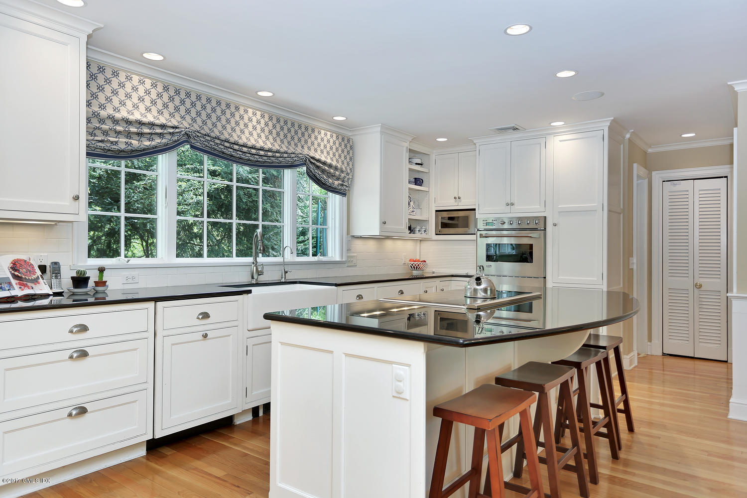 87 Hunting Ridge Road Stamford, CT 06903 - Photo 5 of 31 a kitchen with stainless steel appliances granite countertop a stove a sink a microwave a dining table and chairs
