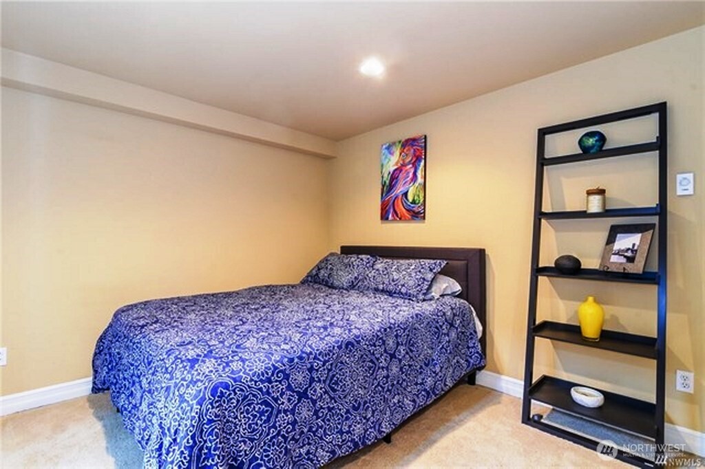 725 North 95th Street, Unit C Seattle, WA 98103 - Photo 10 of 18 a bedroom with a bed and painting on the wall