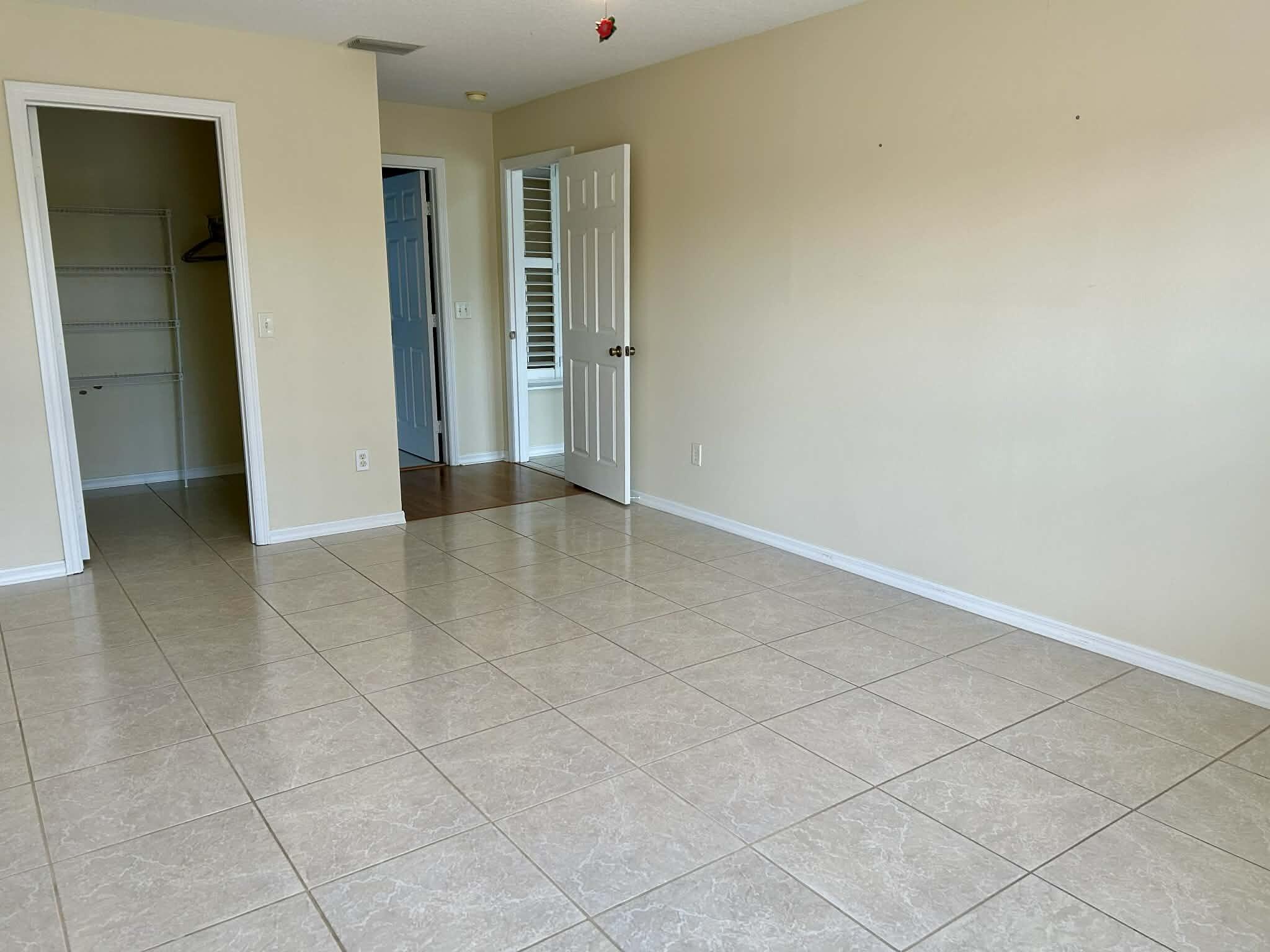 5593 Northwest Wesley Road Port St. Lucie, FL 34986 - Photo 8 of 33 Owner's suite with walk-in closet