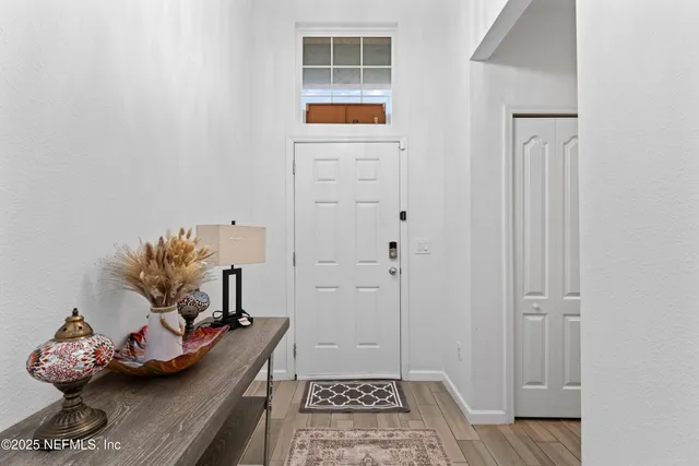 a kitchen with a sink stainless steel appliances and white cabinets