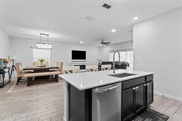 a kitchen with kitchen island wooden cabinets and refrigerator