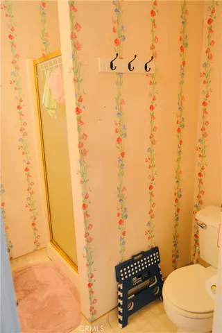 a bathroom with a toilet and shower