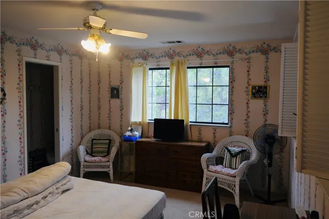 a bedroom with furniture and a window