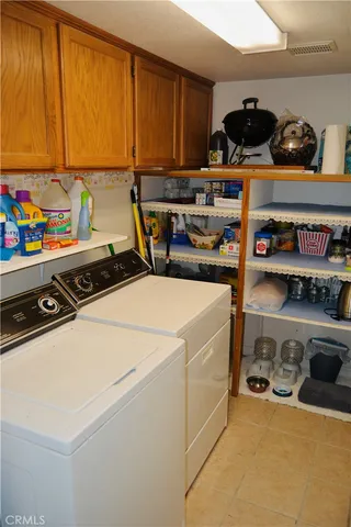 a view of storage and utility room with washer and dryer