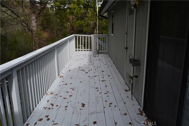 a view of balcony with wooden floor and fence