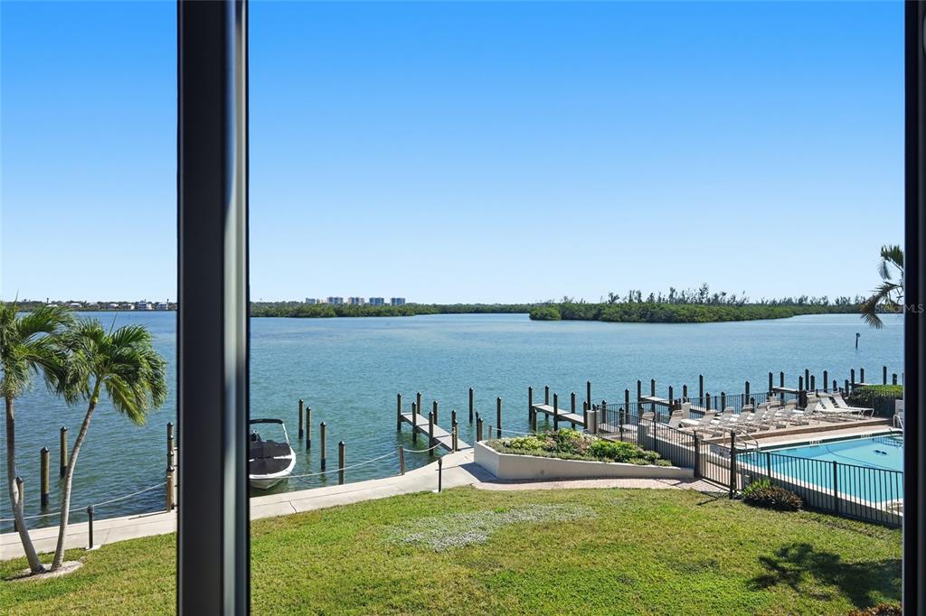 8977 Midnight Pass Road, Unit 223 Sarasota, FL 34242 - Photo 14 of 82 a view of a lake from a yard with seating area