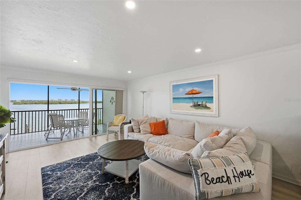 8977 Midnight Pass Road, Unit 223 Sarasota, FL 34242 - Photo 17 of 82 a living room with furniture and a floor to ceiling window