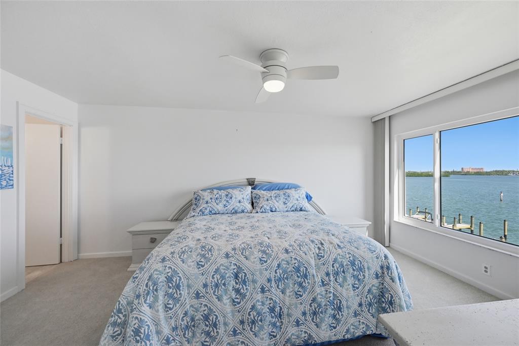 8977 Midnight Pass Road, Unit 223 Sarasota, FL 34242 - Photo 22 of 82 a bedroom with a bed and a large window with outer view