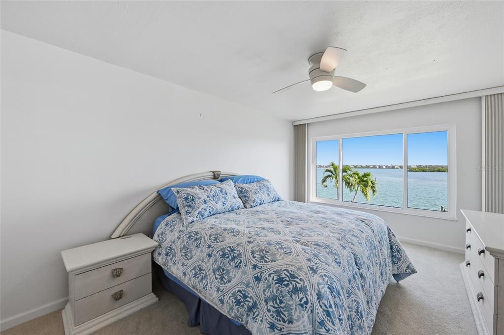 8977 Midnight Pass Road, Unit 223 Sarasota, FL 34242 - Photo 24 of 82 a bedroom with a bed and a window