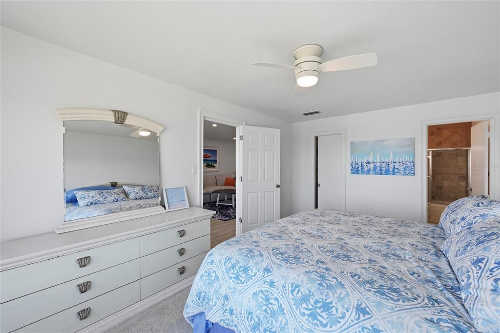 8977 Midnight Pass Road, Unit 223 Sarasota, FL 34242 - Photo 25 of 82 a bedroom with a large bed and a large mirror
