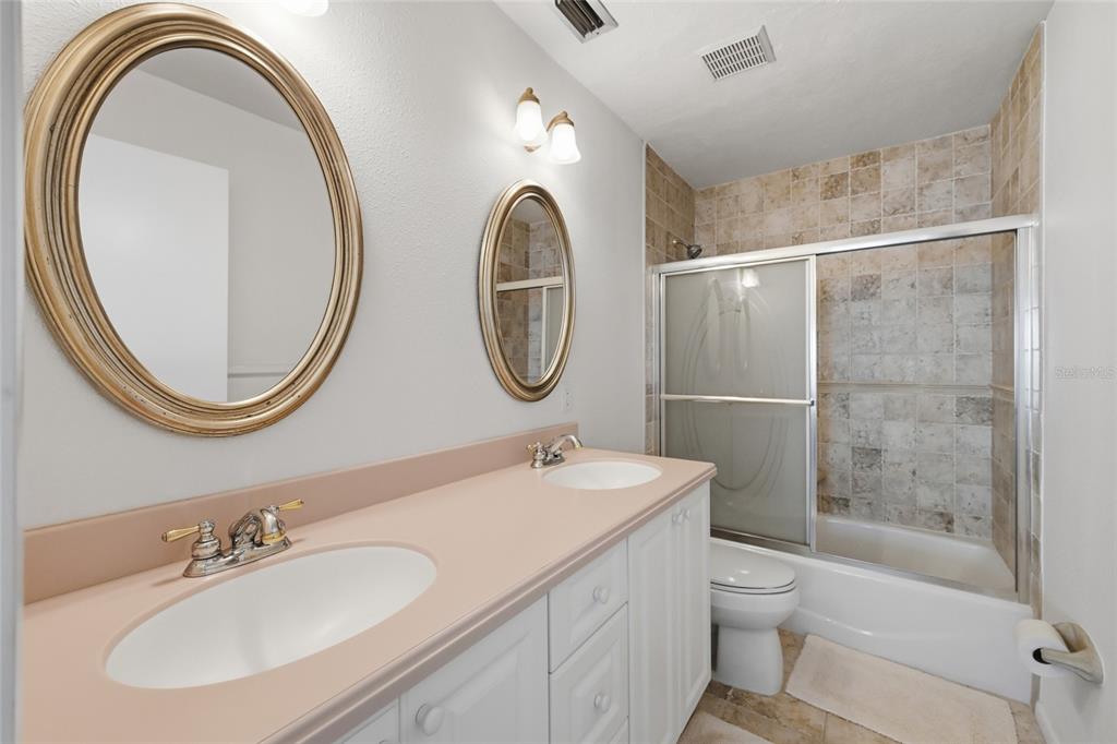 8977 Midnight Pass Road, Unit 223 Sarasota, FL 34242 - Photo 26 of 82 a bathroom with a toilet a sink and a mirror