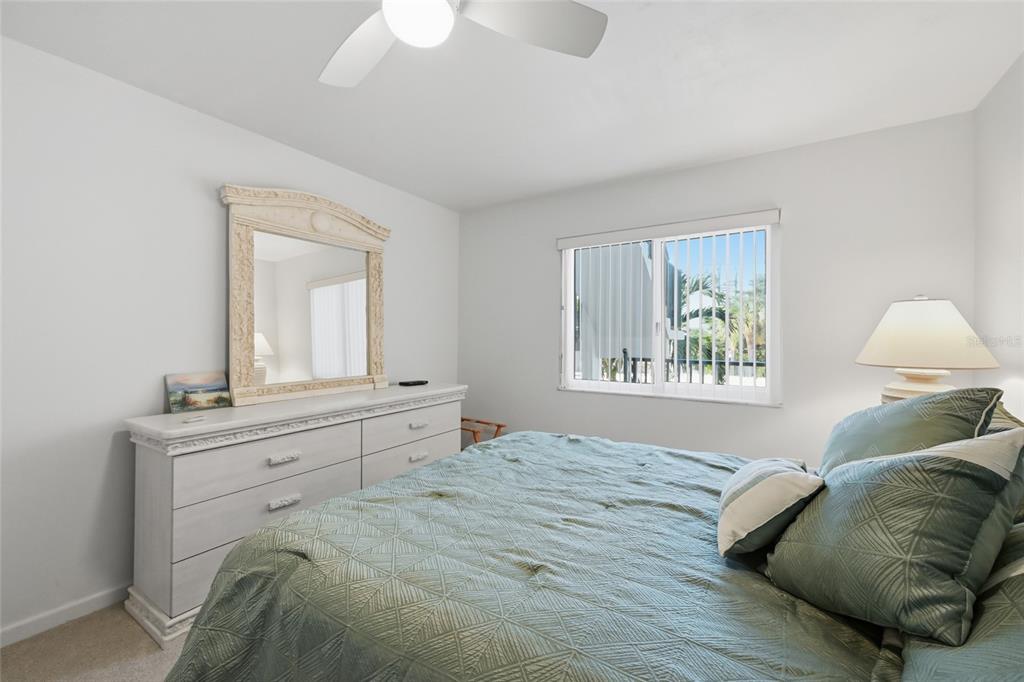 8977 Midnight Pass Road, Unit 223 Sarasota, FL 34242 - Photo 29 of 82 a bedroom with a bed and a window