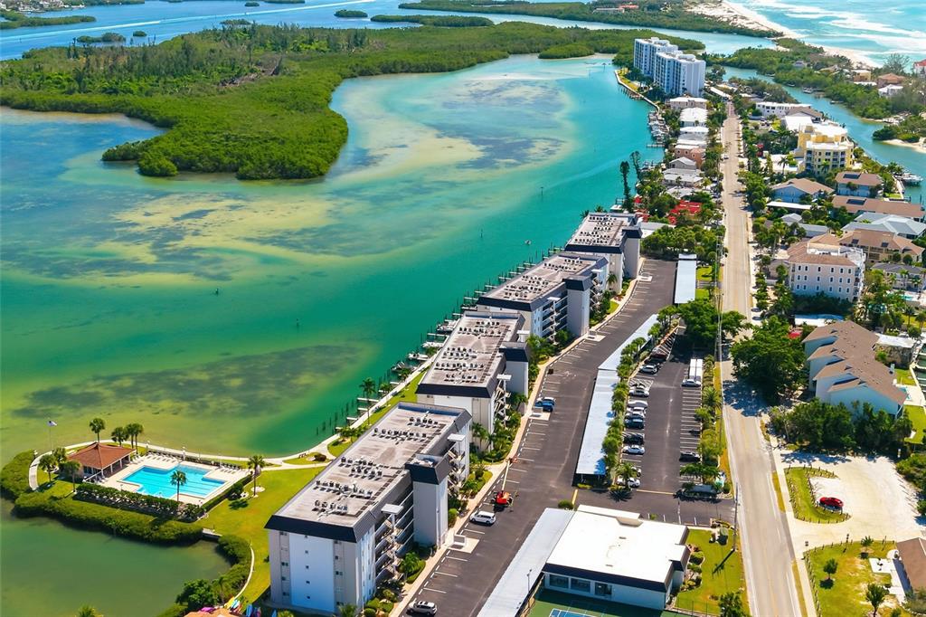 8977 Midnight Pass Road, Unit 223 Sarasota, FL 34242 - Photo 3 of 82 an aerial view of a house with a garden and lake view