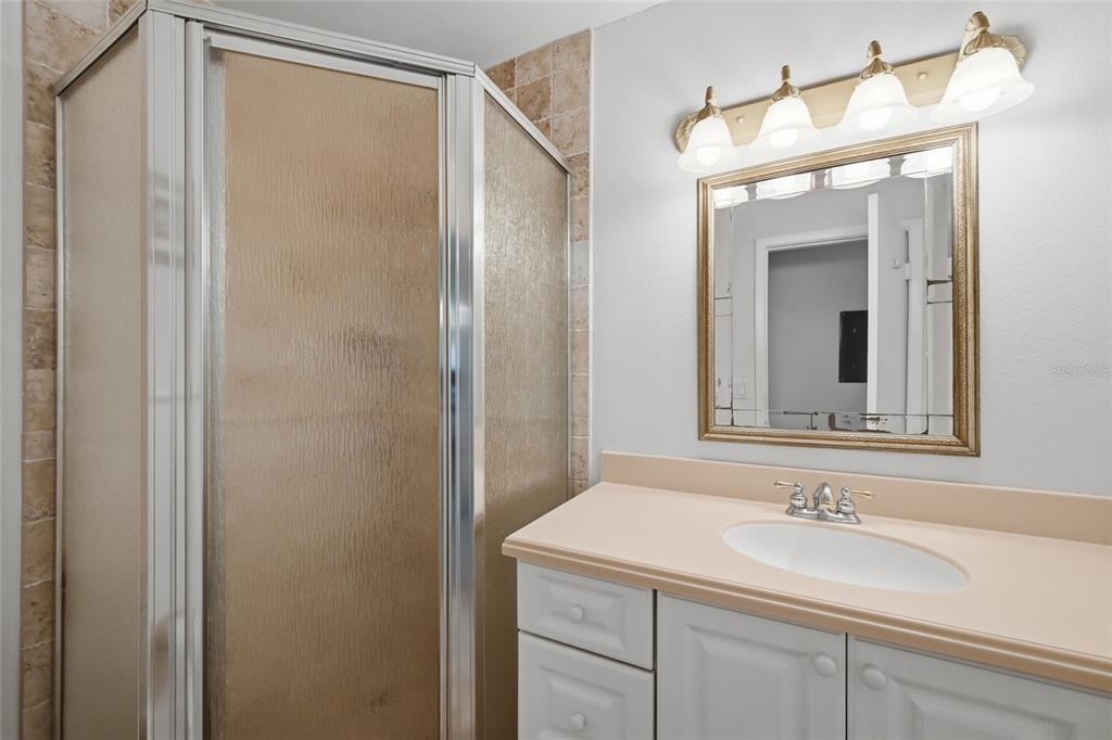 8977 Midnight Pass Road, Unit 223 Sarasota, FL 34242 - Photo 31 of 82 a bathroom with a sink and a mirror