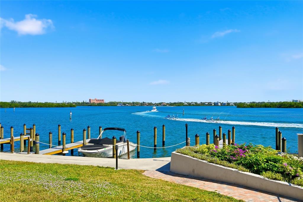 8977 Midnight Pass Road, Unit 223 Sarasota, FL 34242 - Photo 43 of 82 a view of a house with floor to ceiling windows and yard