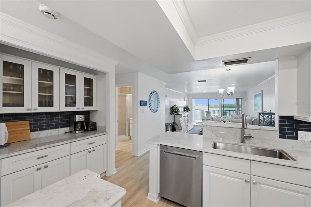 8977 Midnight Pass Road, Unit 223 Sarasota, FL 34242 - Photo 5 of 82 a kitchen with granite countertop a sink and cabinets