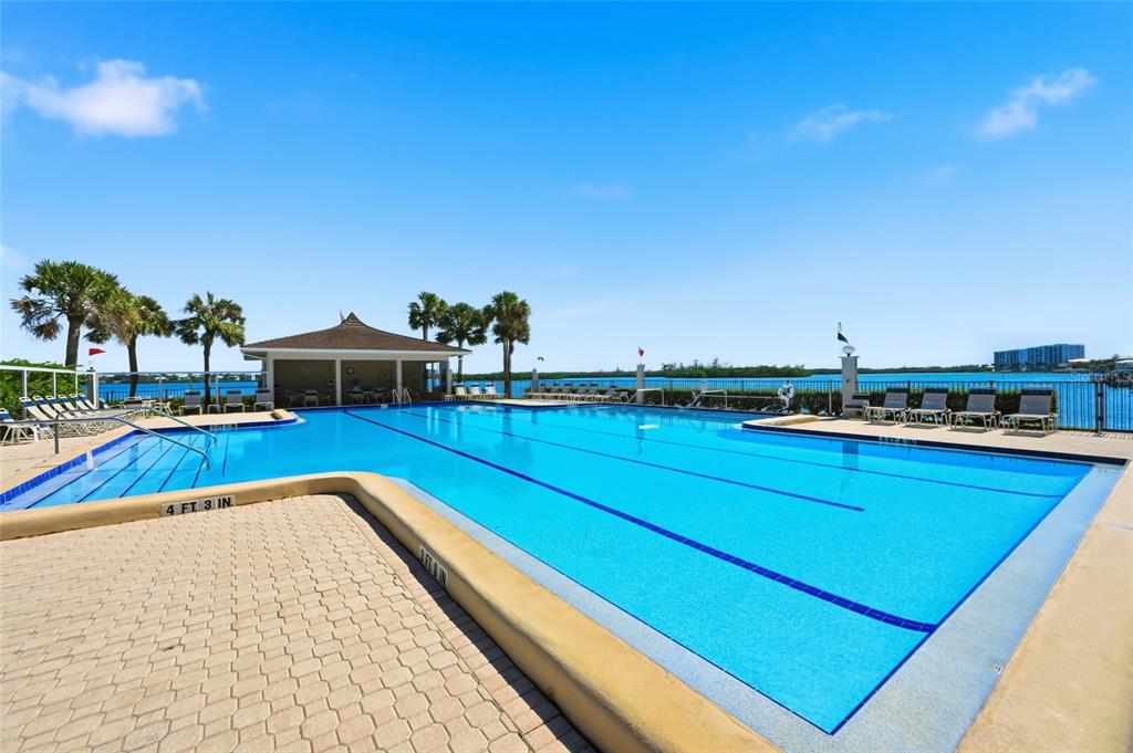 8977 Midnight Pass Road, Unit 223 Sarasota, FL 34242 - Photo 51 of 82 a view of a swimming pool with an outdoor seating and deck