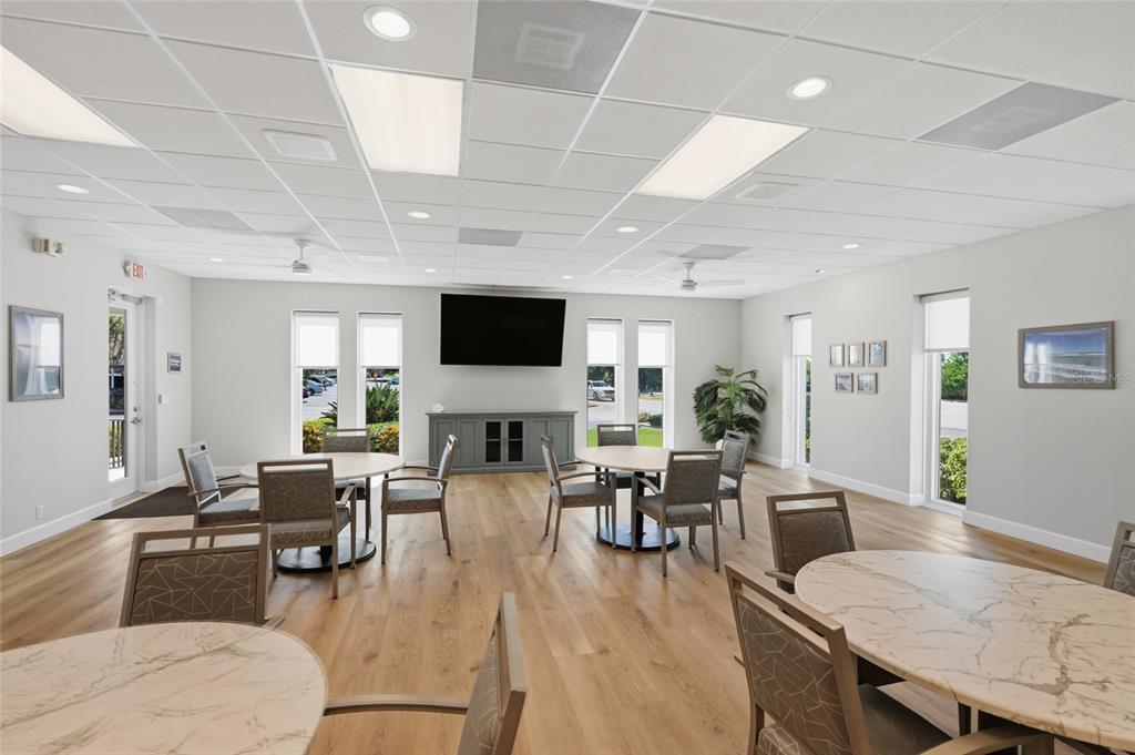 8977 Midnight Pass Road, Unit 223 Sarasota, FL 34242 - Photo 61 of 82 a living room with furniture a fireplace and a flat screen tv