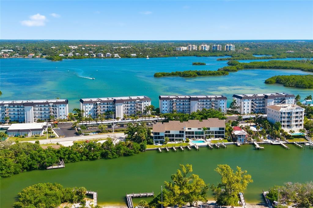 8977 Midnight Pass Road, Unit 223 Sarasota, FL 34242 - Photo 67 of 82 a view of a city with lawn chairs under an umbrella