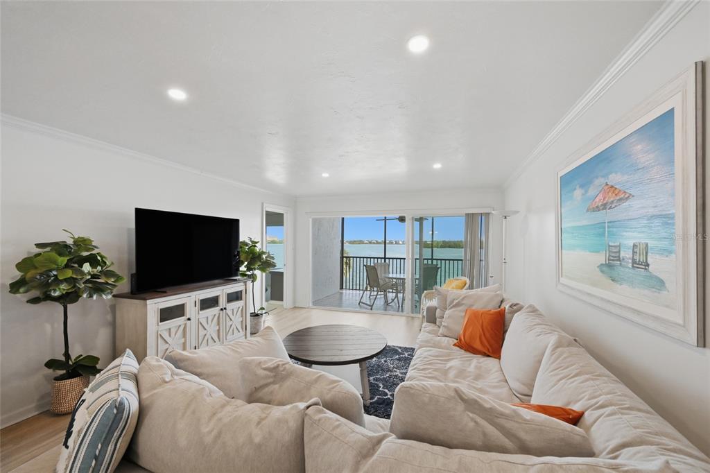 8977 Midnight Pass Road, Unit 223 Sarasota, FL 34242 - Photo 9 of 82 a living room with furniture and a flat screen tv