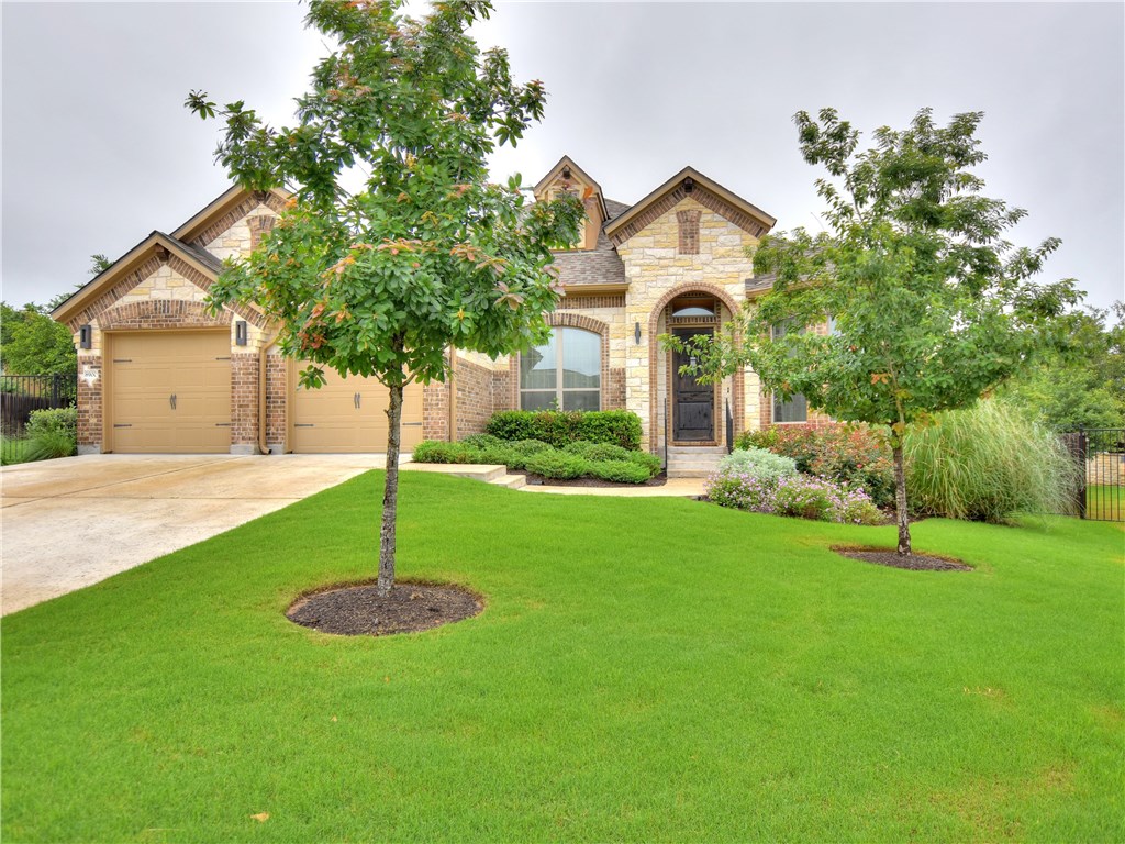 8900 Geranium Cove Austin, TX 78738 - Photo 1 of 1 a front view of a house with a yard and a tree