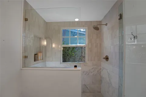 a bathroom with a bathtub and shower
