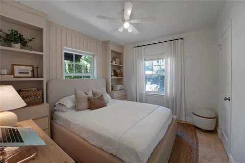 a bedroom with a large bed couch and a window