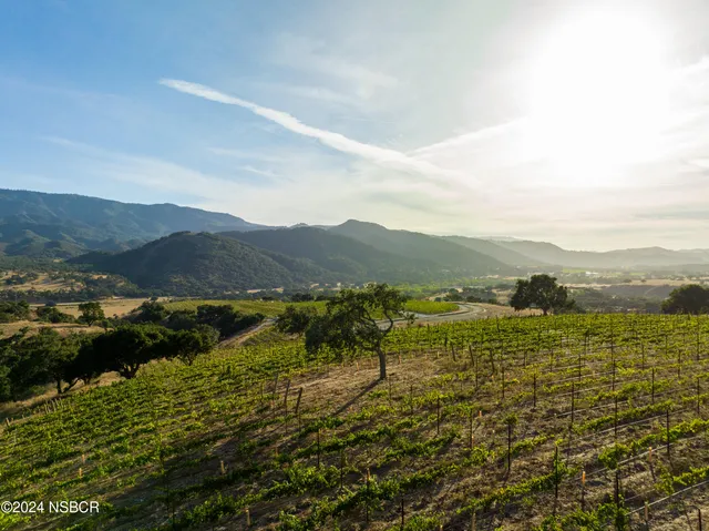 a living room with furniture a flat screen tv and a large window