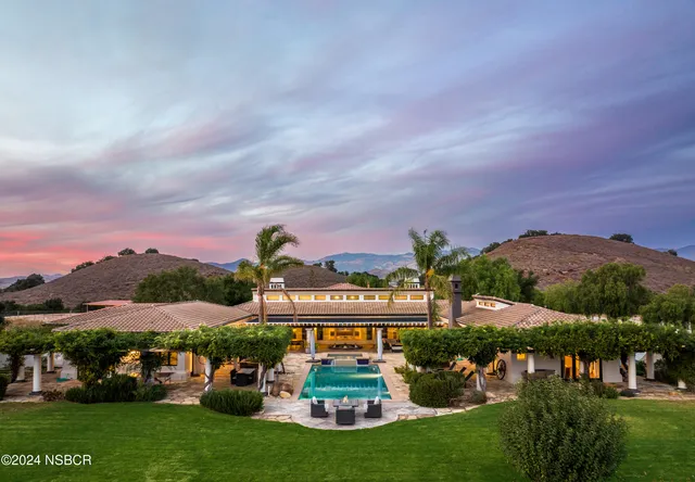 a view of a big yard with a barn