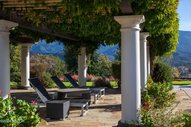 a outdoor living space with patio furniture and a fireplace