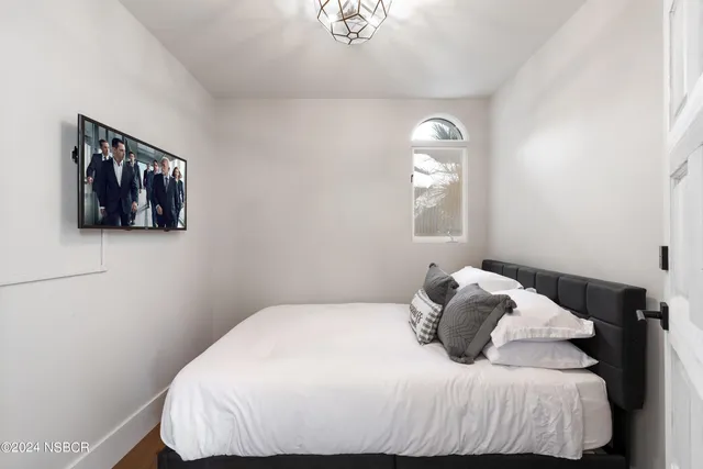 a bedroom with a bed and window