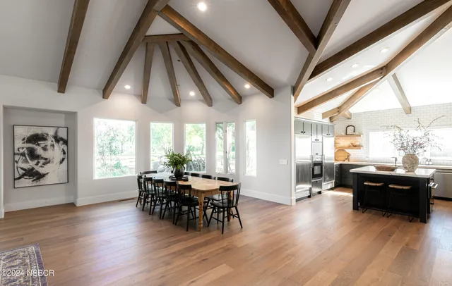 an aerial view of residential houses with outdoor space and city view