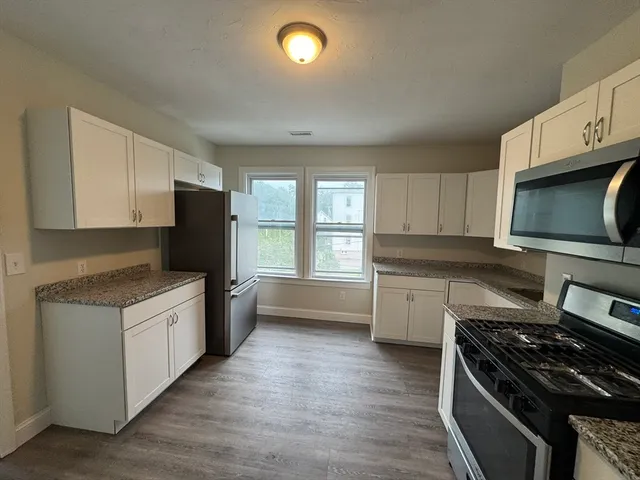 a kitchen with a stove a sink and a microwave