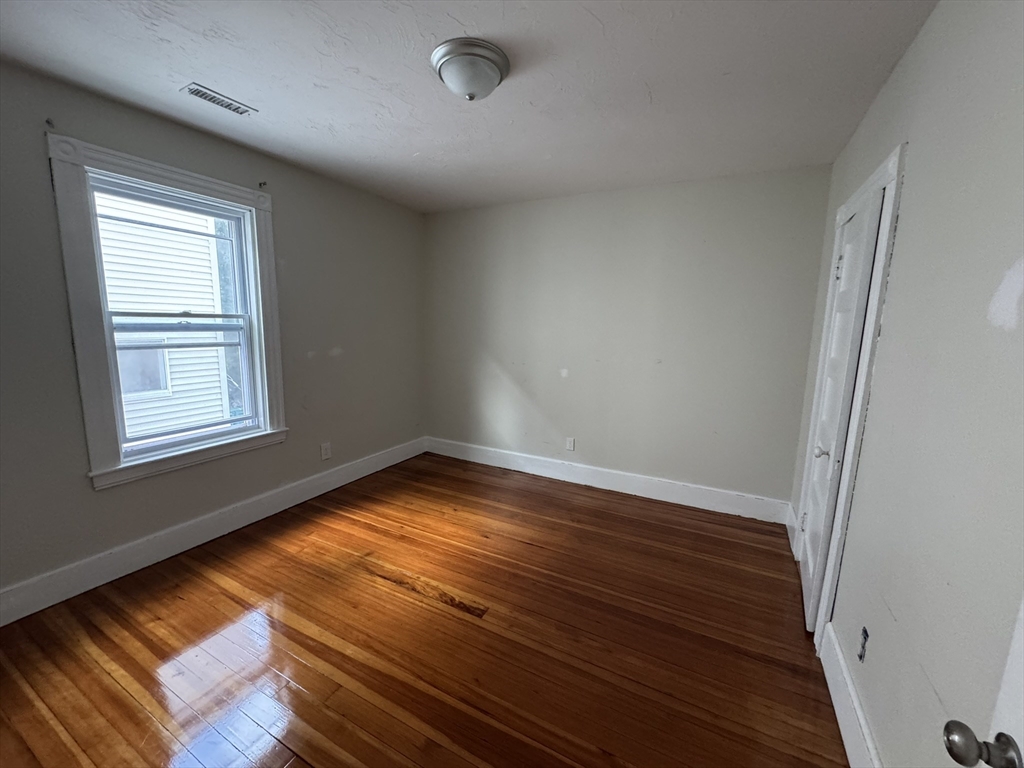 72 Forest Street, Unit 2 Attleboro, MA 02703 - Photo 8 of 10 a view of empty room with wooden floor and fan